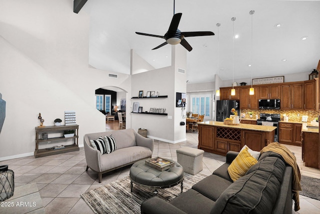 living room featuring ceiling fan, high vaulted ceiling, and light tile patterned floors