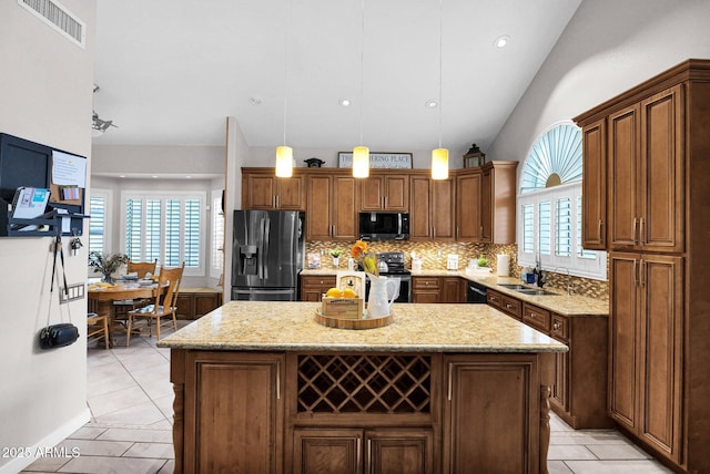 kitchen with hanging light fixtures, a kitchen island, fridge with ice dispenser, and electric range