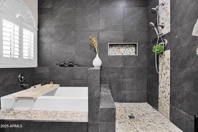 bathroom featuring shower with separate bathtub