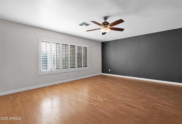 spare room with wood-type flooring and ceiling fan