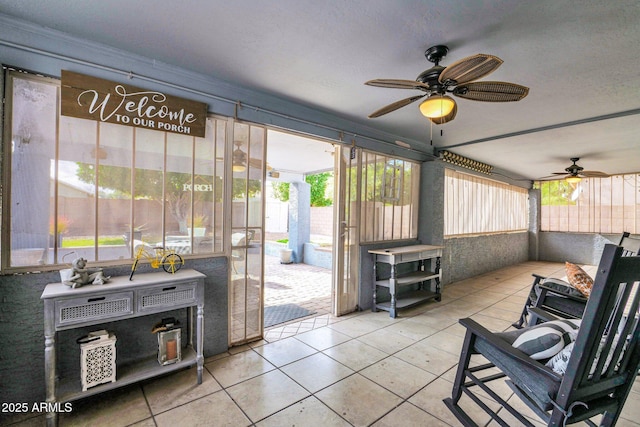 sunroom / solarium with ceiling fan