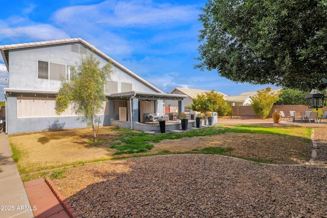 exterior space featuring a pergola, a patio, and an outdoor living space with a fire pit