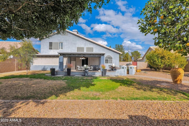 back of house with a yard and a patio area