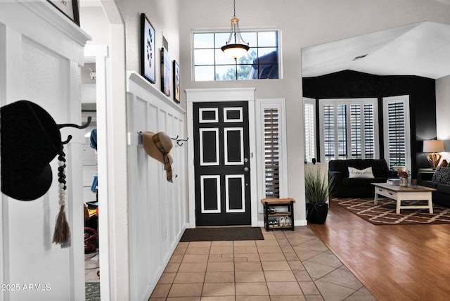 foyer with lofted ceiling and tile patterned floors