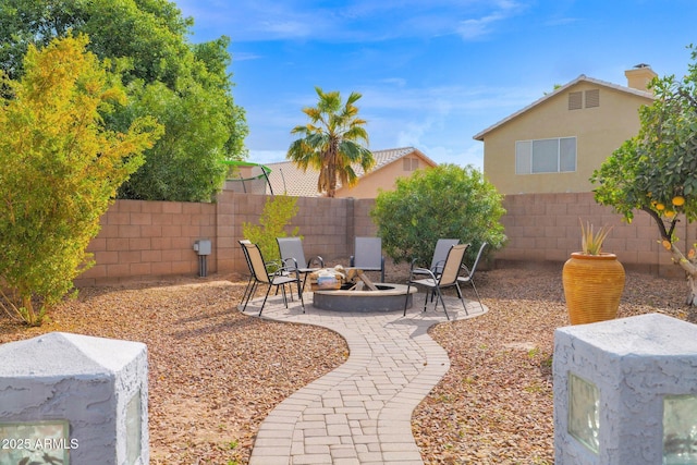 view of yard featuring an outdoor fire pit and a patio area