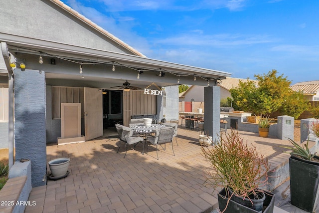 view of patio featuring an outdoor kitchen and ceiling fan