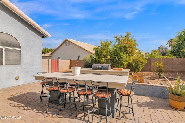 view of patio featuring a bar and area for grilling