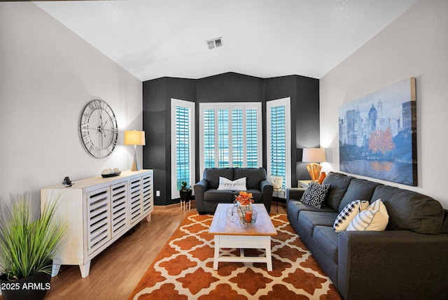 living room with lofted ceiling and hardwood / wood-style floors