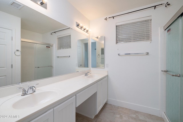 bathroom featuring tile patterned flooring, vanity, and an enclosed shower