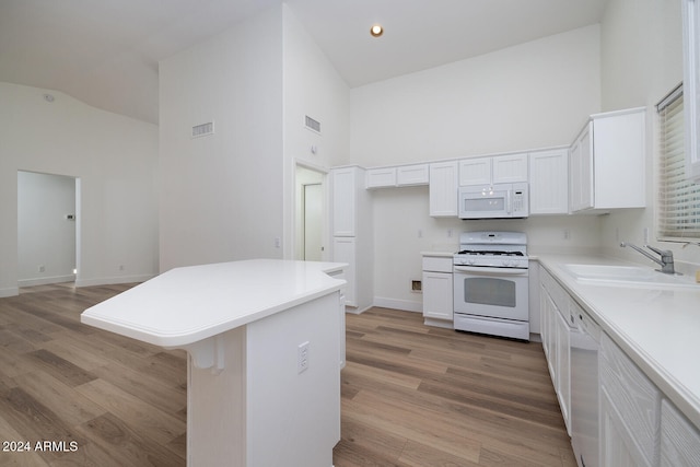 kitchen featuring sink, high vaulted ceiling, white appliances, and light wood-type flooring