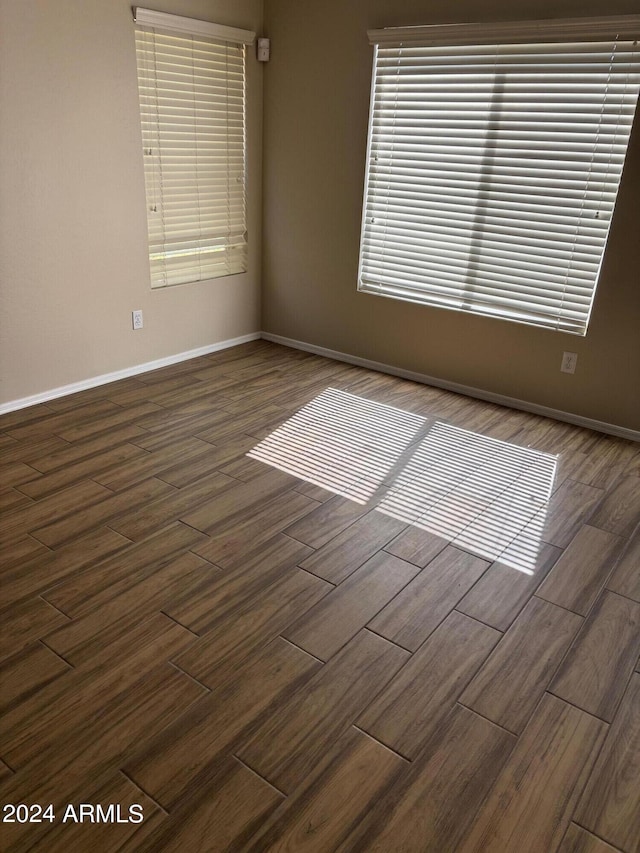 spare room featuring dark hardwood / wood-style floors