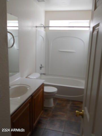 full bathroom featuring vanity, bathing tub / shower combination, toilet, and tile patterned floors