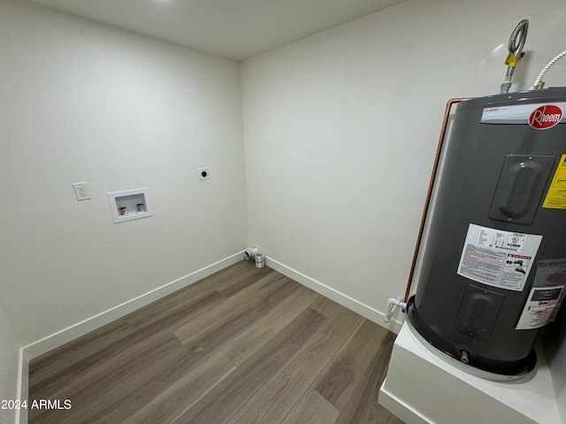 clothes washing area featuring hookup for an electric dryer, hookup for a washing machine, water heater, and dark hardwood / wood-style flooring