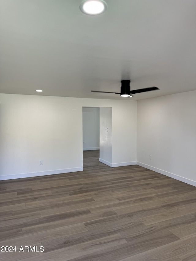 empty room with ceiling fan and wood-type flooring