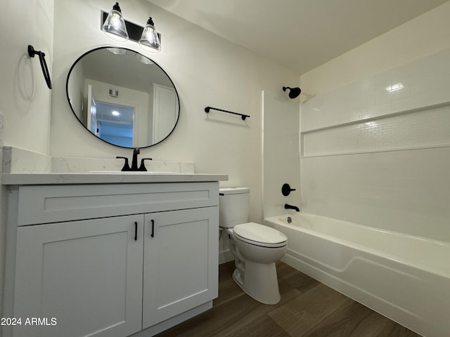 full bathroom featuring toilet, hardwood / wood-style floors, vanity, and shower / bath combination