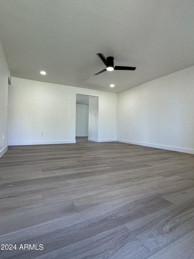 spare room with ceiling fan and wood-type flooring