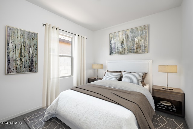 bedroom with dark colored carpet