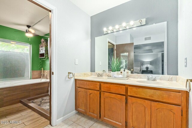 18585 N 70th Ave, Glendale, AZ 85308 - bathroom featuring visible vents, tiled tub, a sink, a ceiling fan, and double vanity