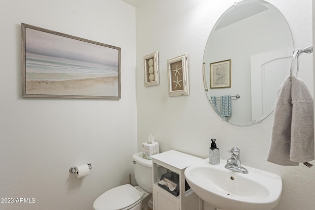 bathroom featuring sink and toilet