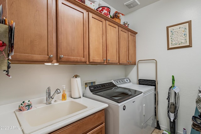 laundry area with cabinets, sink, and washer and dryer