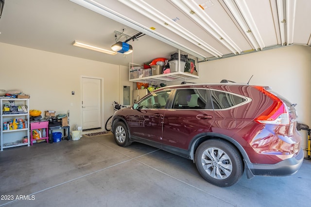 garage featuring a garage door opener and electric panel