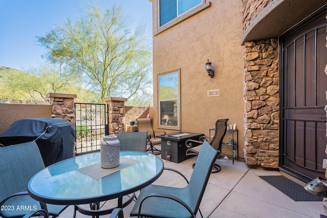 view of patio with a grill and a fire pit