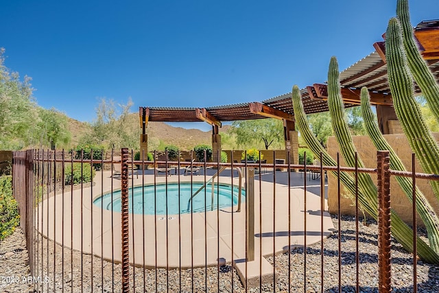 view of swimming pool with a hot tub, a mountain view, a patio area, and a pergola