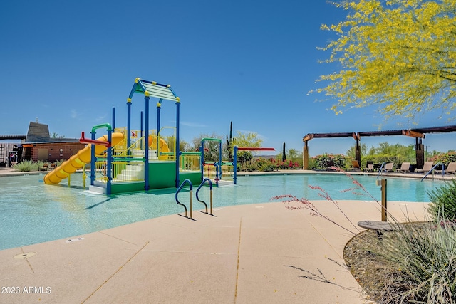 view of swimming pool with a water slide and a playground