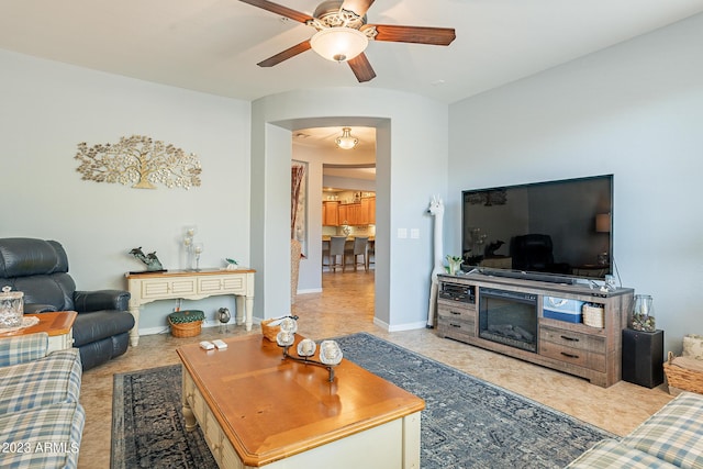 tiled living room featuring ceiling fan