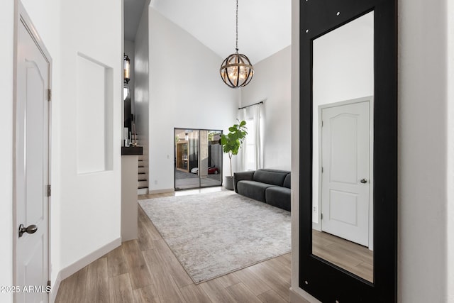 2533 W Novak Way, Phoenix, AZ 85041 - corridor featuring a chandelier, light wood-style floors, and high vaulted ceiling