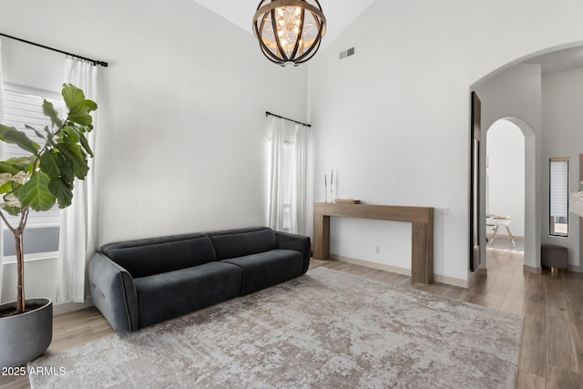 2533 W Novak Way, Phoenix, AZ 85041 - living room with arched walkways, plenty of natural light, wood finished floors, and high vaulted ceiling