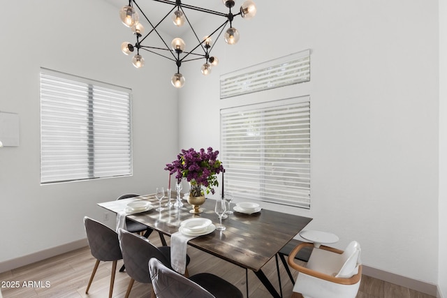 2533 W Novak Way, Phoenix, AZ 85041 - dining area with a chandelier, baseboards, and light wood-style floors