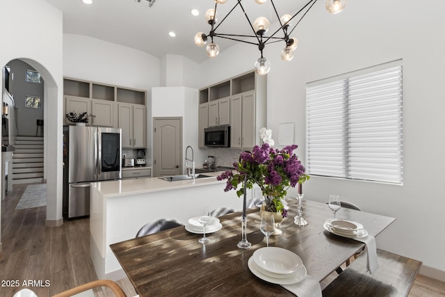 2533 W Novak Way, Phoenix, AZ 85041 - dining space with arched walkways, stairs, wood finished floors, recessed lighting, and a chandelier