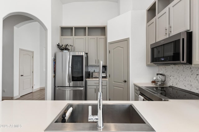 2533 W Novak Way, Phoenix, AZ 85041 - kitchen featuring stainless steel appliances, open shelves, and backsplash