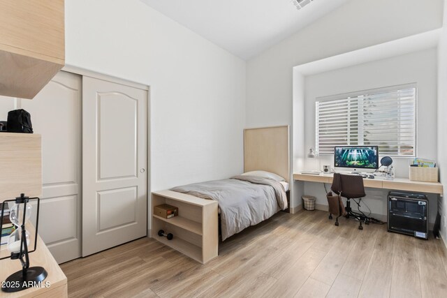 2533 W Novak Way, Phoenix, AZ 85041 - bedroom with light wood-style floors, a desk, and a closet