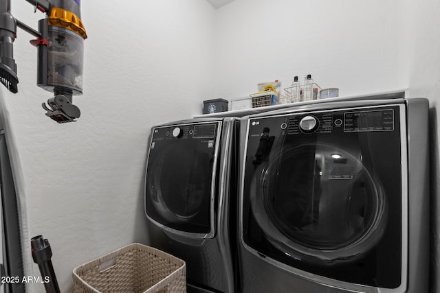 2533 W Novak Way, Phoenix, AZ 85041 - clothes washing area with a textured wall and separate washer and dryer