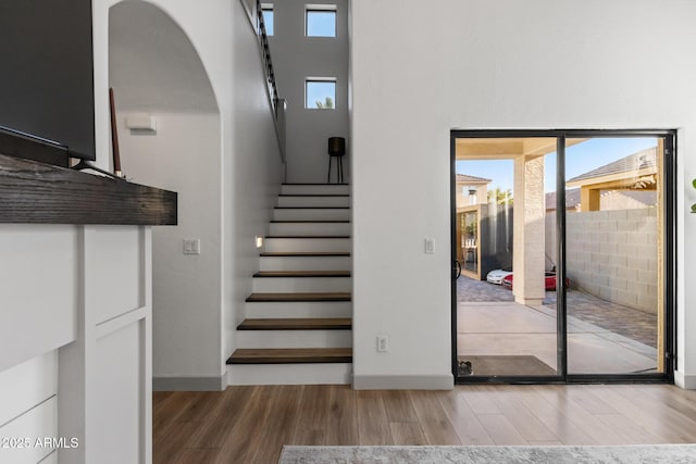2533 W Novak Way, Phoenix, AZ 85041 - stairs featuring wood finished floors, arched walkways, and baseboards