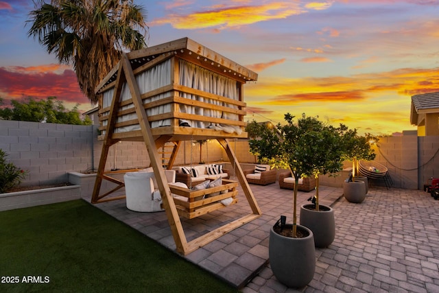 2533 W Novak Way, Phoenix, AZ 85041 - patio terrace at dusk with an outdoor living space and a fenced backyard