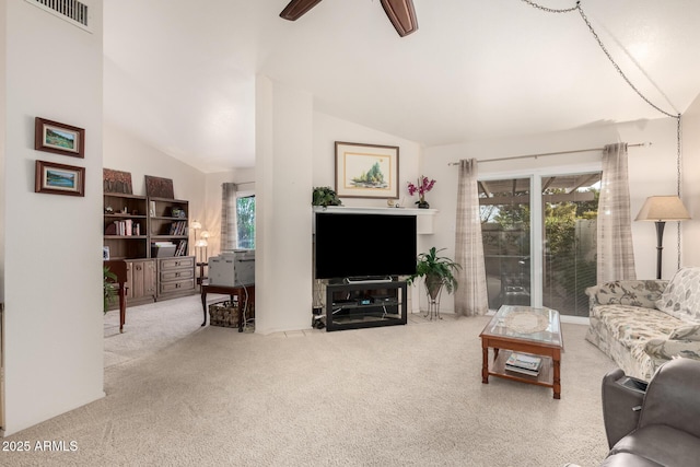 carpeted living room featuring ceiling fan and lofted ceiling