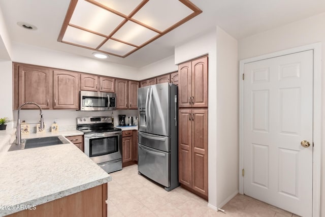 kitchen with sink and appliances with stainless steel finishes