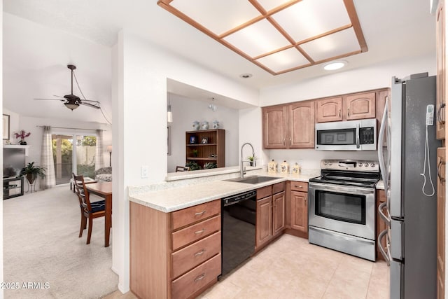 kitchen featuring sink, ceiling fan, light carpet, and appliances with stainless steel finishes