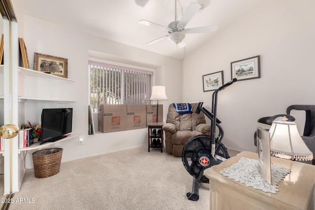 interior space featuring ceiling fan, vaulted ceiling, and carpet flooring