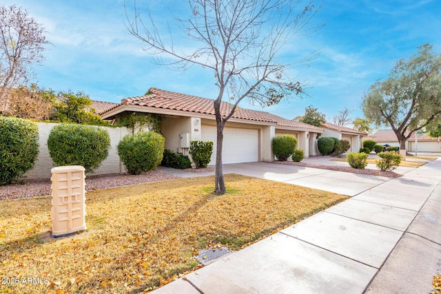 mediterranean / spanish house with a garage and a front yard