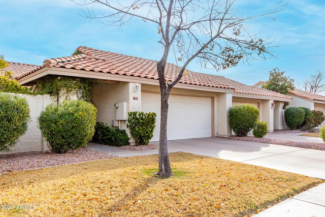 mediterranean / spanish-style house with a garage and a front yard