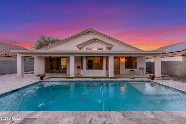 pool at dusk with a fenced in pool, a patio area, and a fenced backyard