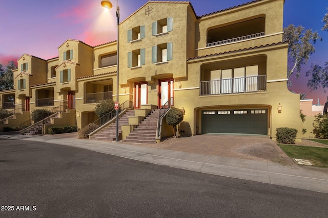 mediterranean / spanish-style home with a garage