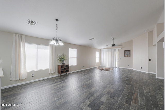 unfurnished living room with ceiling fan with notable chandelier and dark hardwood / wood-style flooring