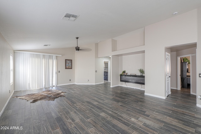 unfurnished living room with vaulted ceiling, ceiling fan, and dark wood-type flooring