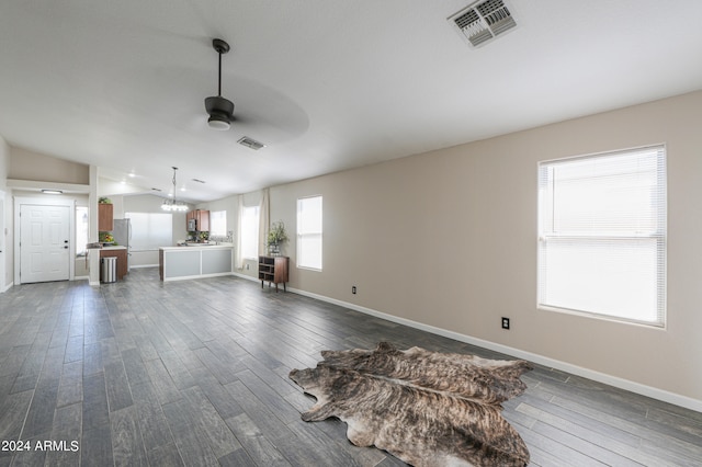 unfurnished living room with ceiling fan, lofted ceiling, and dark wood-type flooring