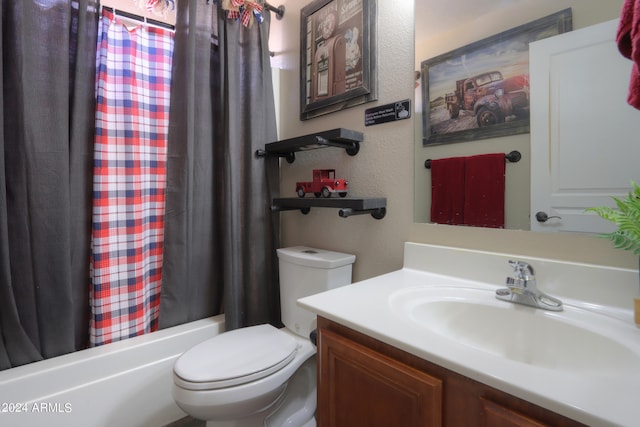 full bathroom featuring shower / bathtub combination with curtain, vanity, and toilet